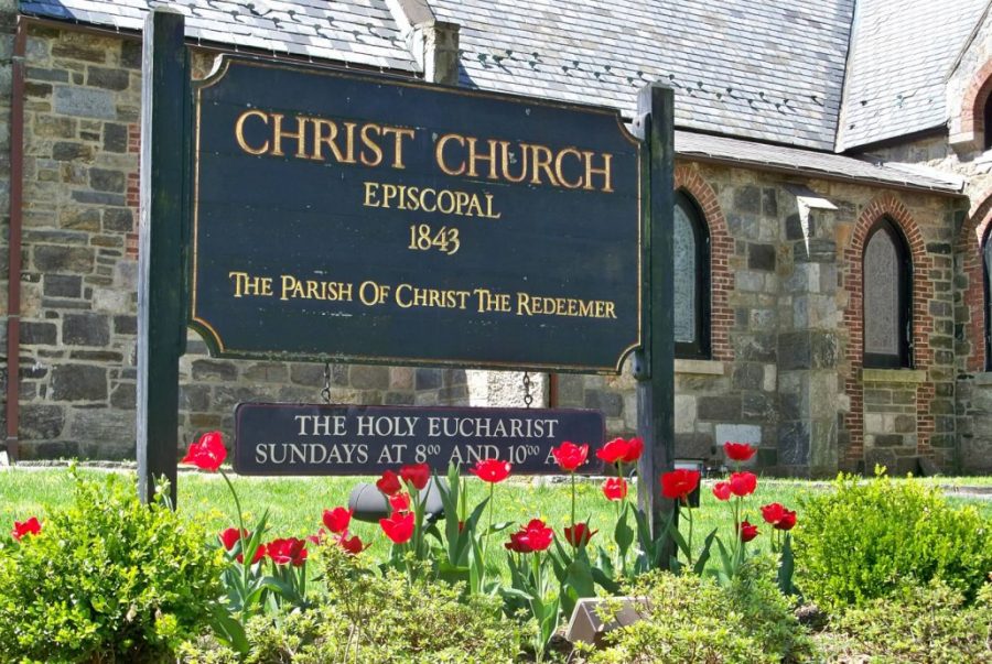 Photograph of exterior of Gothic style church with signage identifying the church and date of its founding.